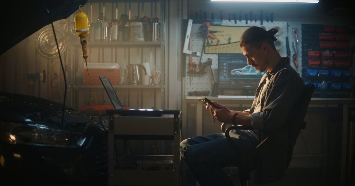 Technician analyzing real-time diagnostic data on a tablet in a garage